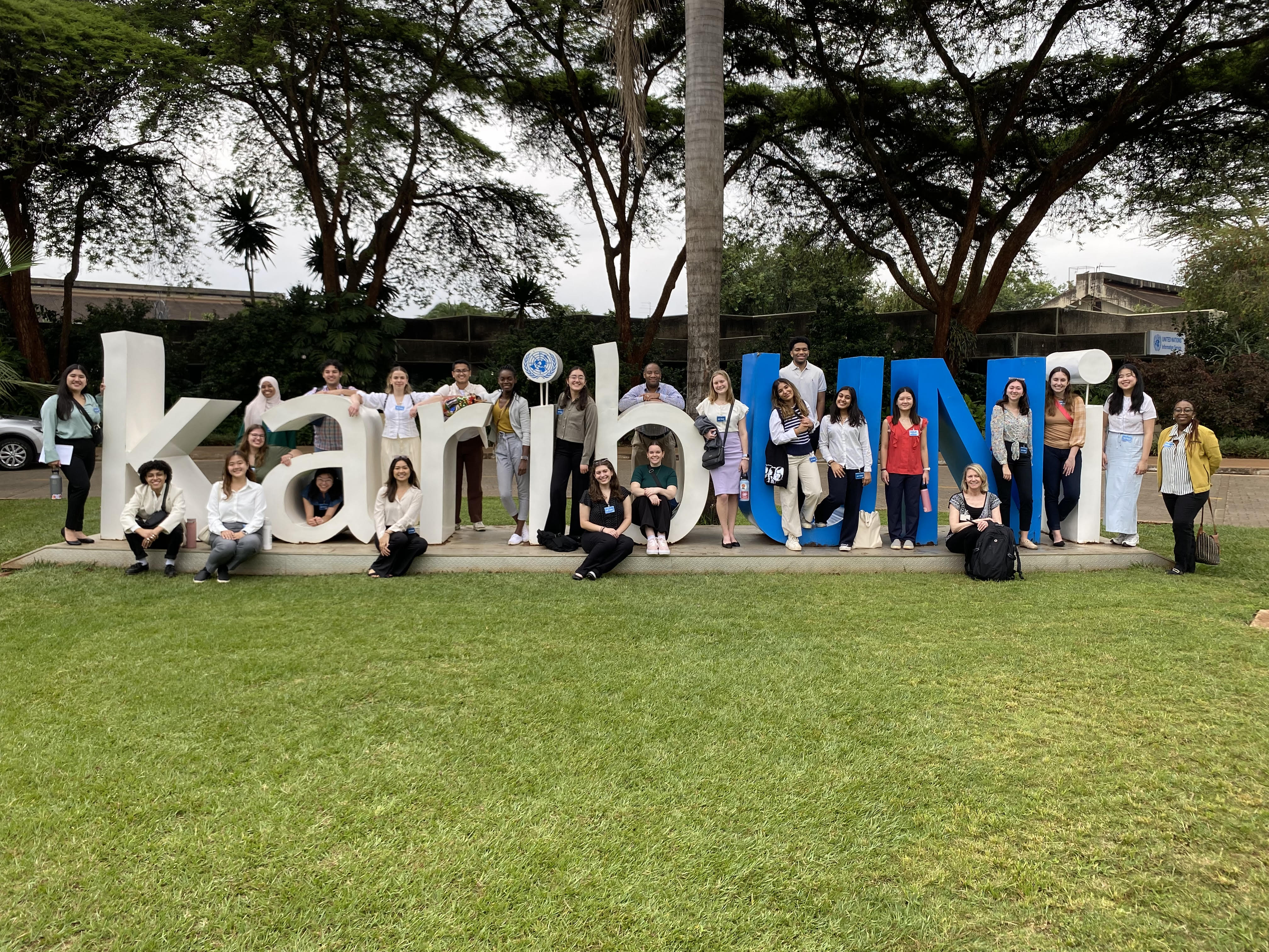 Many people pose around large letters that spell "karibUNi"