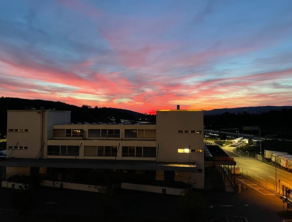 Colorful sunset behind a multi-storey building